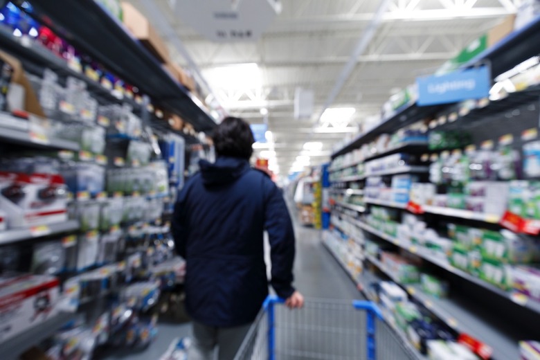 man in grocery store with shopping cart