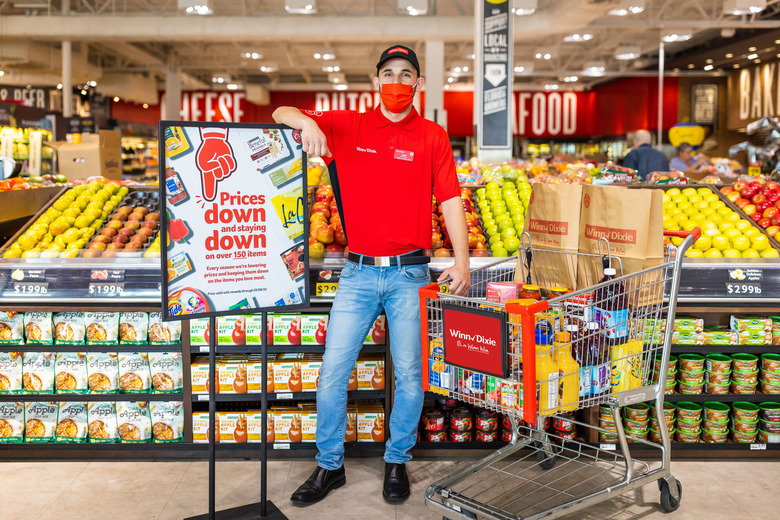 masked man stands in grocery store