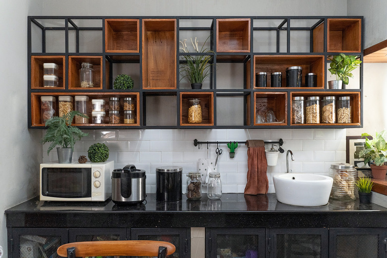 A kitchen with modern storage and various appliances on the counter