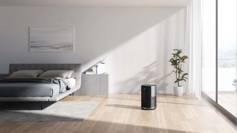 Sitting on the floor is an air purifier