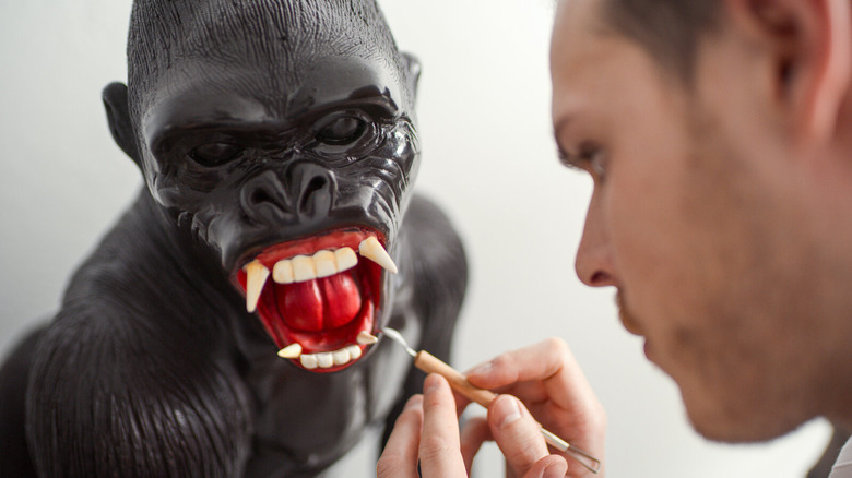 man painting chocolate gorilla