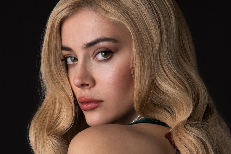 woman with blonde hair looking over her shoulder