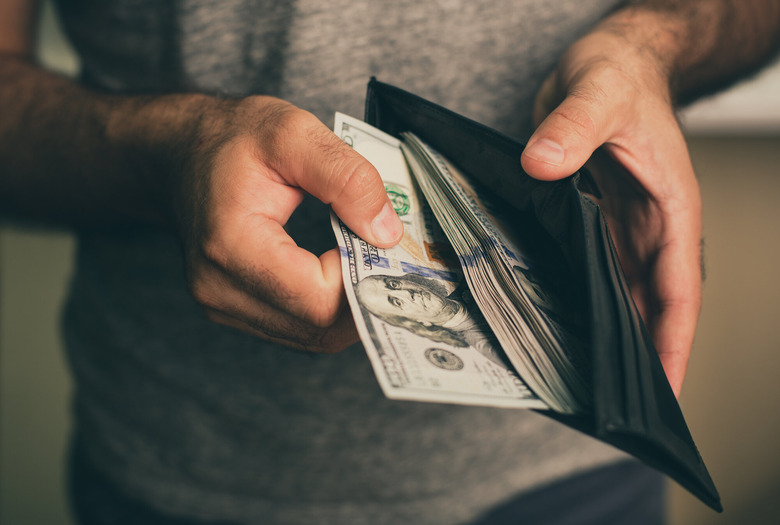 Man counting money in wallet