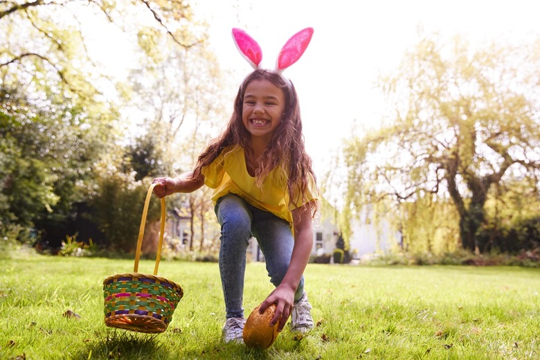 A girl on an Easter egg hunt in a garden