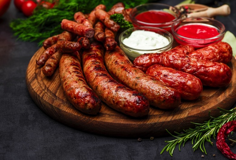 Various types of sausages grilled on a platter.