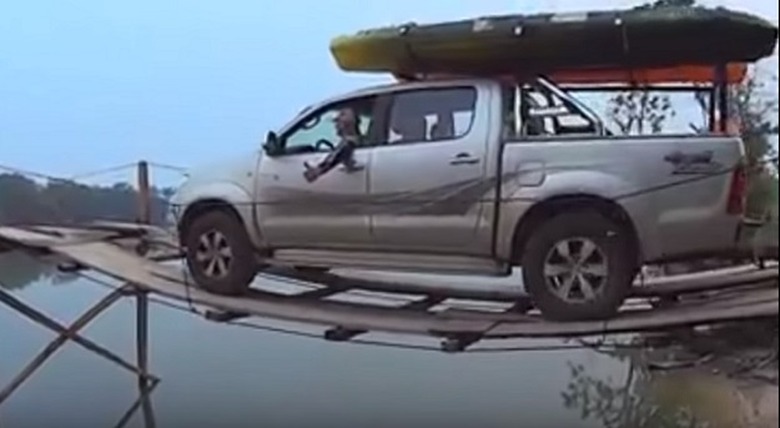 truck driving across bridge