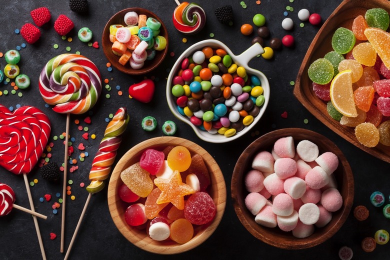 Colorful candies, jelly and marmalade on stone background