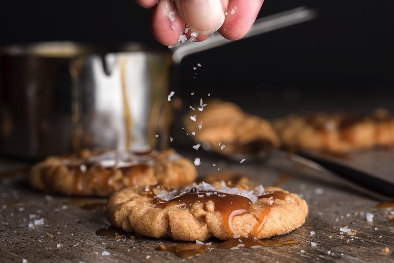 A person making salted caramel cookies.