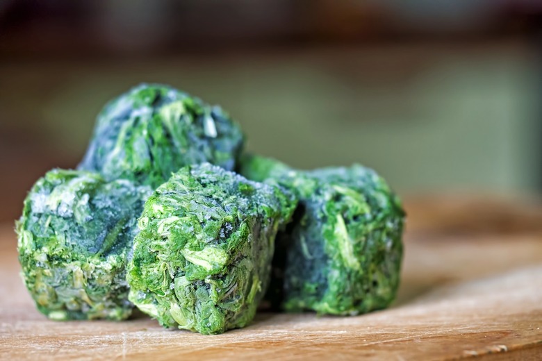 Frozen spinach cubes on a cutting board