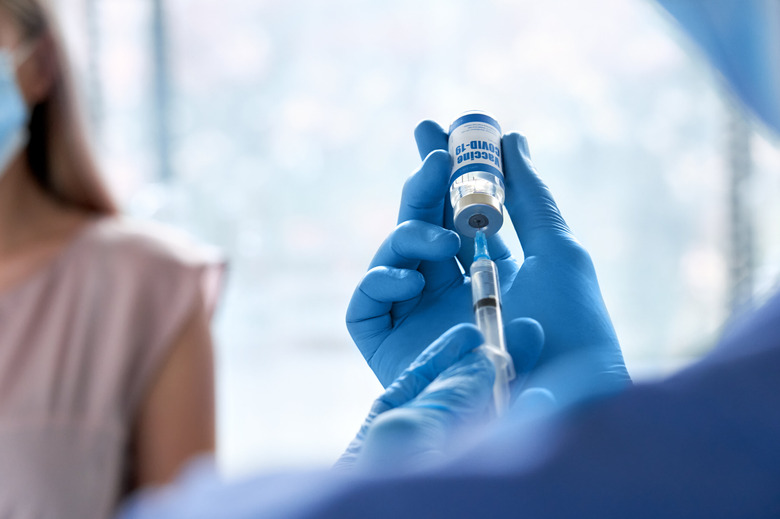 Doctor holding syringe