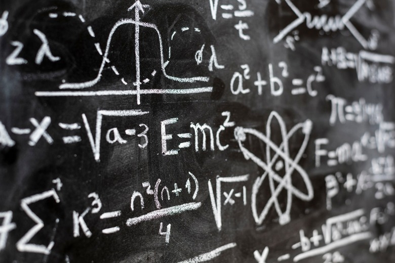 physics equations on a chalk board