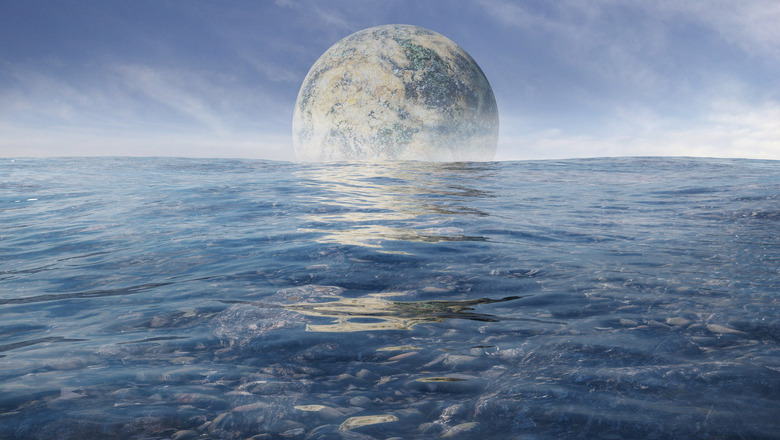 ocean world with moon rising over it