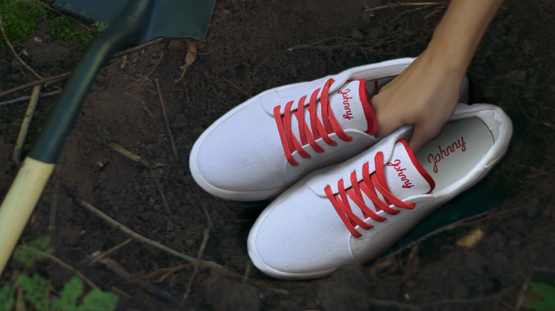 someone planting Johnny Footwear shoes