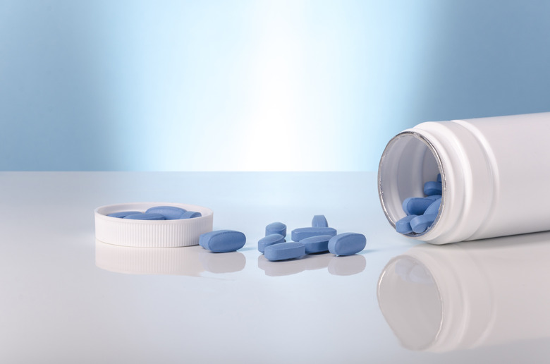 viagra blue tablets over white and blue background.