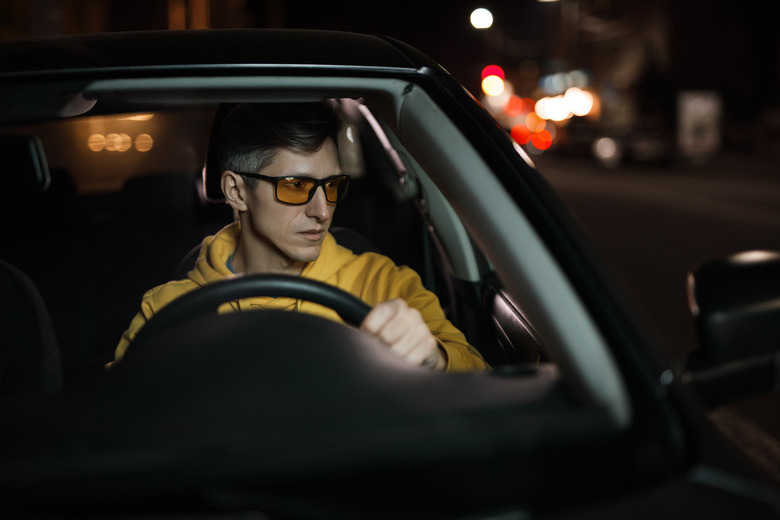 A person driving a car at night.