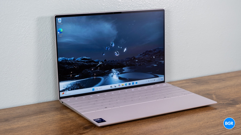 Dell XPS 13 (9350) in white on a wooden table.