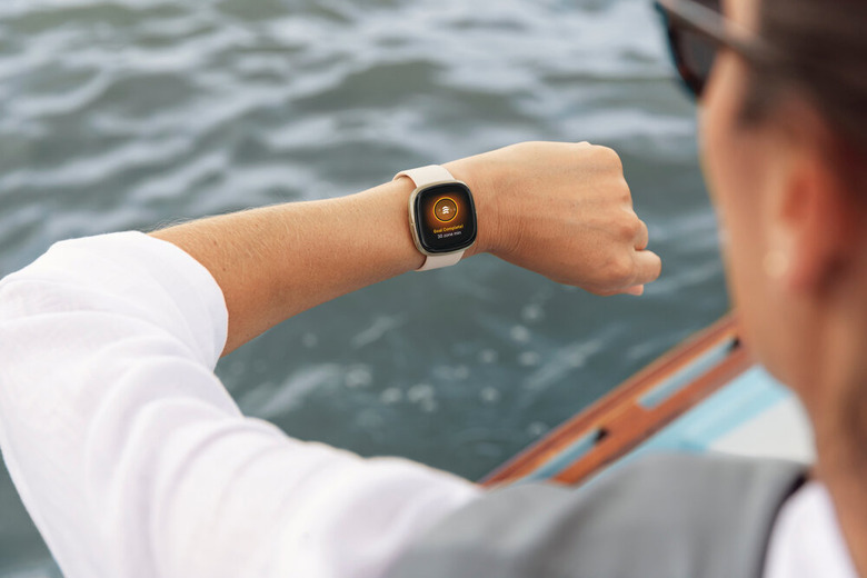 Man checks fitbit on wrist