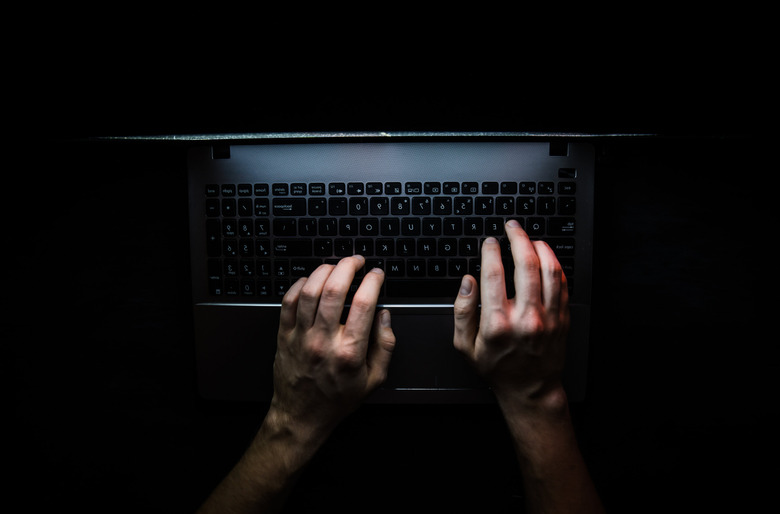 Hands typing on computer keyboard
