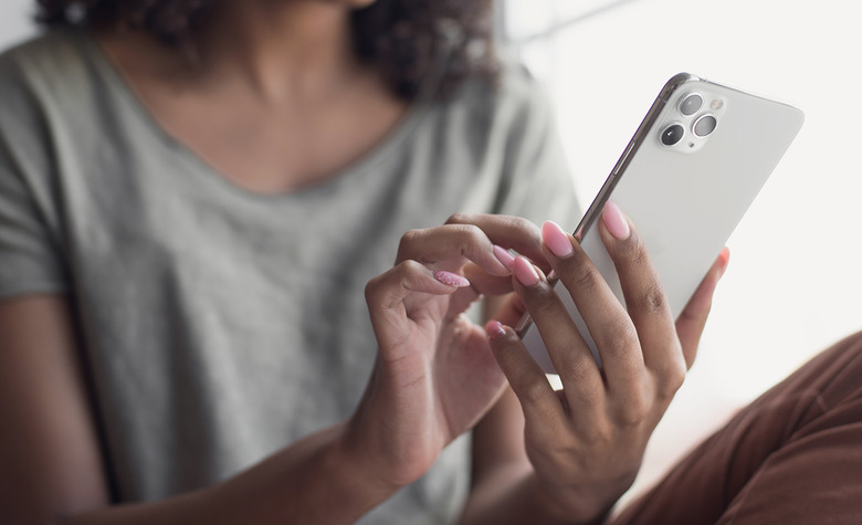 woman holding iPhone 12