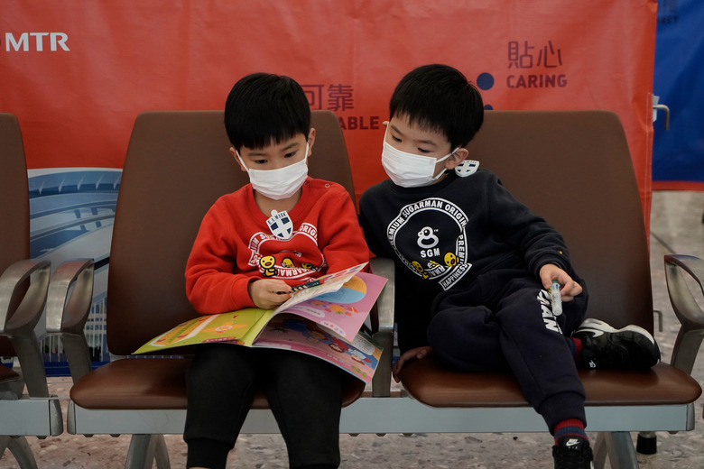 children wearing masks at airport