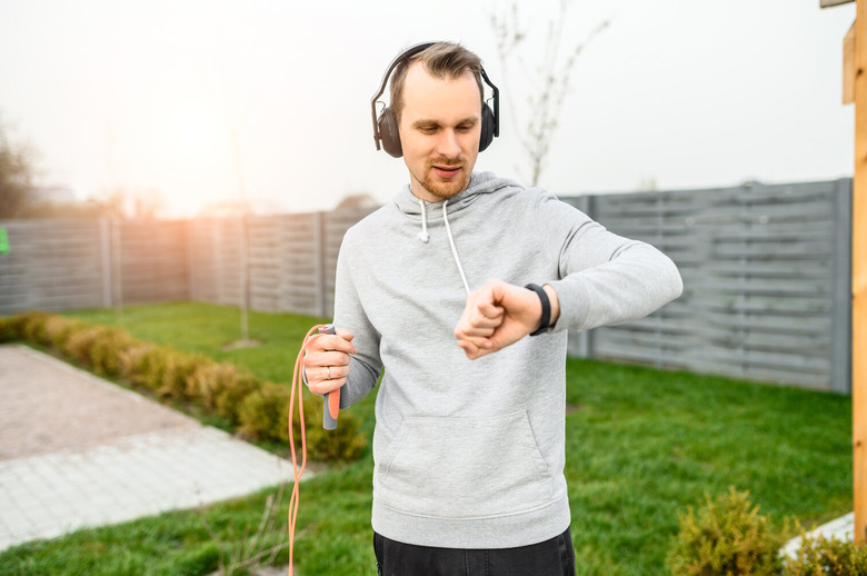 Man with fitness tracker and headphones