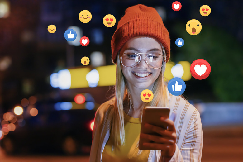 Girl with Facebook on smartphone